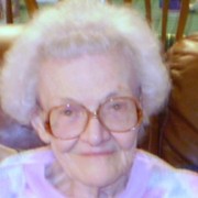 Elderly woman with white hair and glasses